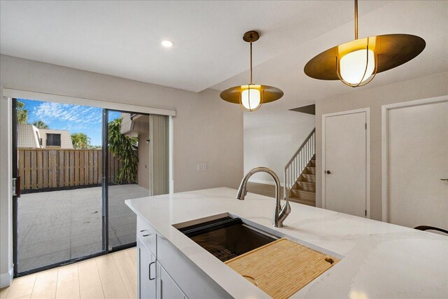6201 62nd Way, West Palm Beach, FL 33409 - kitchen with pendant lighting, light stone counters, recessed lighting, a sink, and light wood-style flooring