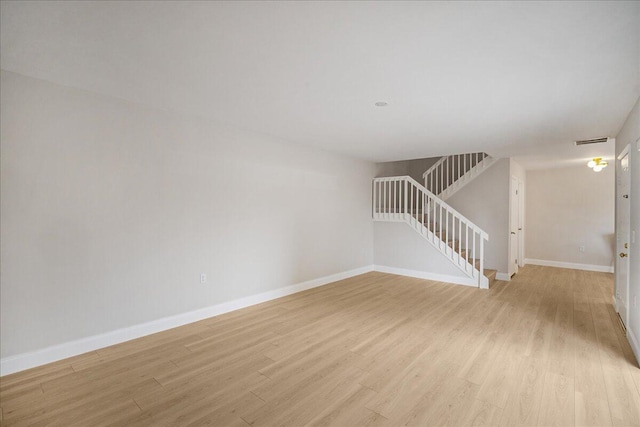6201 62nd Way, West Palm Beach, FL 33409 - unfurnished living room featuring light wood finished floors, baseboards, and stairway