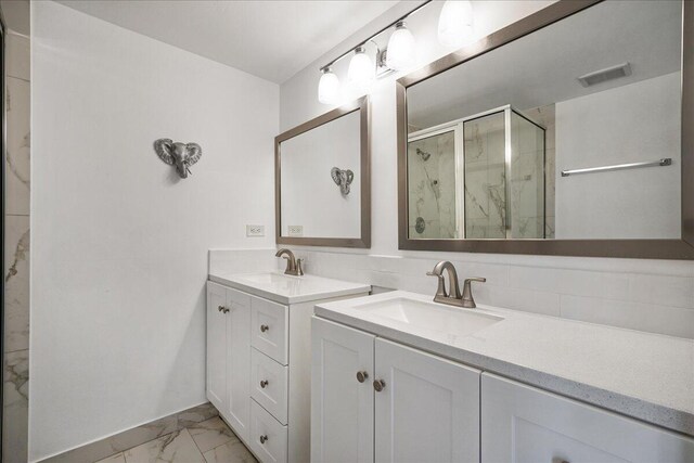 6201 62nd Way, West Palm Beach, FL 33409 - bathroom featuring marble finish floors, a marble finish shower, and two vanities
