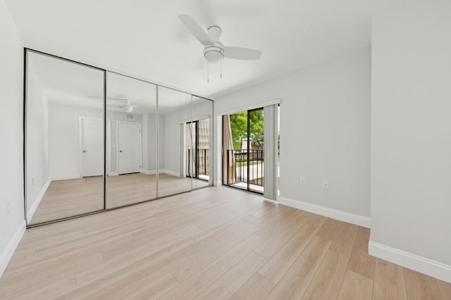 6201 62nd Way, West Palm Beach, FL 33409 - unfurnished bedroom with access to exterior, light wood finished floors, baseboards, a ceiling fan, and a closet