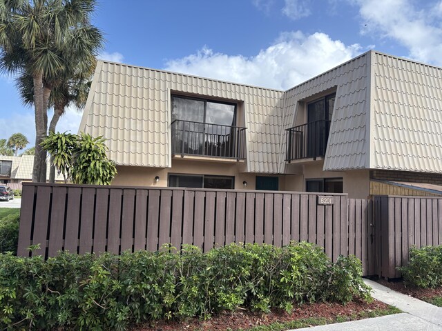 6201 62nd Way, West Palm Beach, FL 33409 - view of property exterior featuring mansard roof and stucco siding