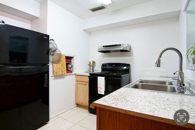 120 Banyan Dr, Port Saint Lucie, FL 34952 - kitchen with black appliances, under cabinet range hood, a sink, light tile patterned floors, and light countertops
