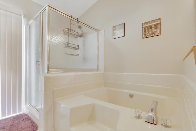 bathroom with a shower stall and a bath