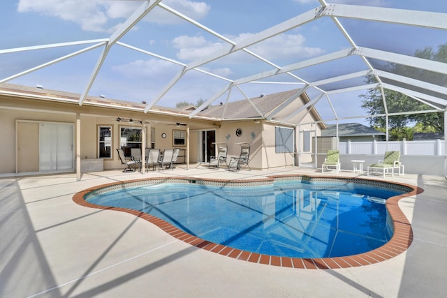view of swimming pool with a ceiling fan, a patio, and a fenced in pool