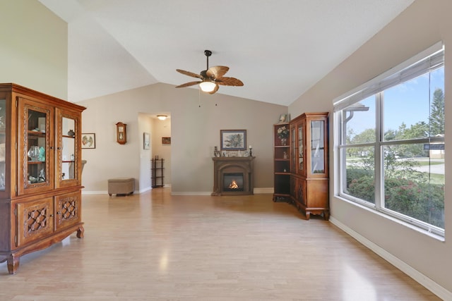 living room with ceiling fan, light wood-style floors, and plenty of natural light