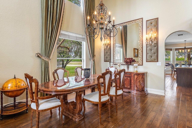 21281 Waycross Dr, Boca Raton, FL 33428 - dining space featuring a chandelier, arched walkways, wood-type flooring, and baseboards