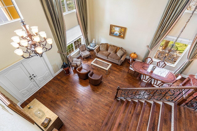 21281 Waycross Dr, Boca Raton, FL 33428 - living area with a chandelier, hardwood / wood-style floors, a towering ceiling, and baseboards