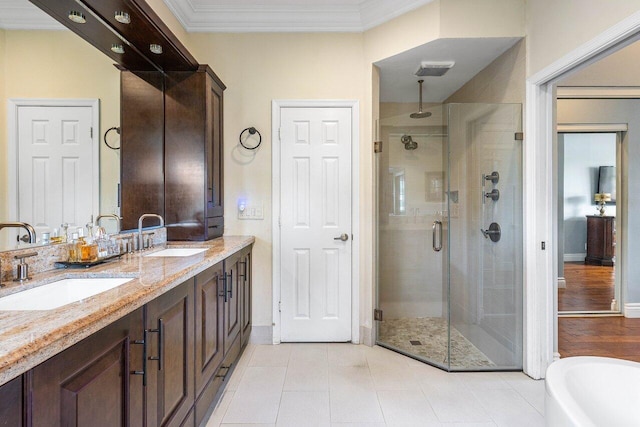 21281 Waycross Dr, Boca Raton, FL 33428 - bathroom featuring a stall shower, double vanity, ornamental molding, a freestanding tub, and baseboards