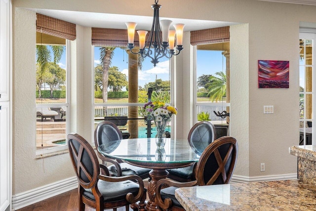 21281 Waycross Dr, Boca Raton, FL 33428 - dining room featuring a textured wall, baseboards, a chandelier, and wood finished floors
