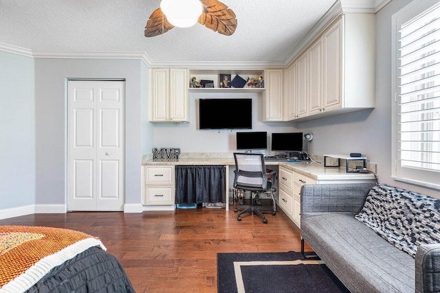 21281 Waycross Dr, Boca Raton, FL 33428 - office with built in desk, dark wood-style flooring, a textured ceiling, crown molding, and baseboards