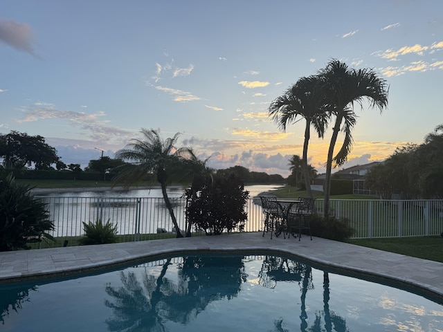 21281 Waycross Dr, Boca Raton, FL 33428 - pool at dusk featuring a water view and a fenced backyard