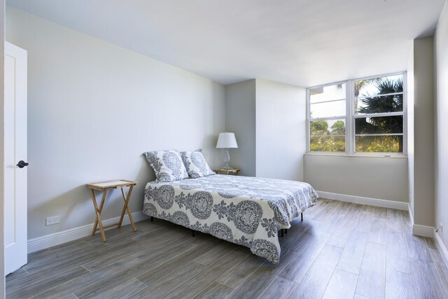 2800 N Flagler Dr Unit 207, West Palm Beach, FL 33407 - bedroom featuring baseboards and wood finished floors