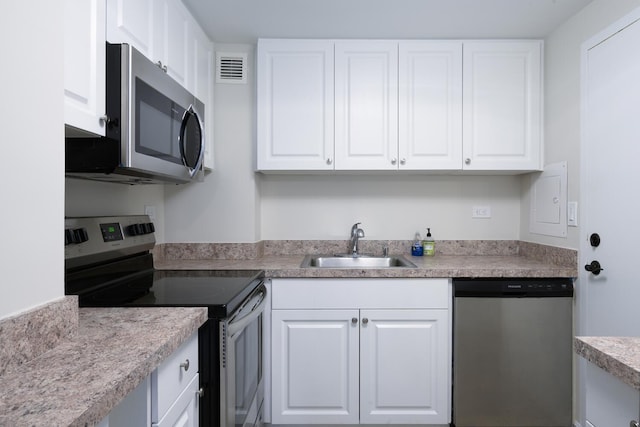 2800 N Flagler Dr Unit 207, West Palm Beach, FL 33407 - kitchen featuring light countertops, white cabinetry, visible vents, stainless steel appliances, and a sink