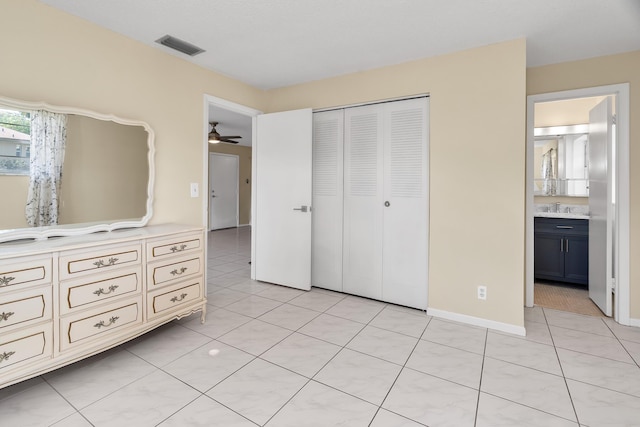 155 Mockingbird Ln, Delray Beach, FL 33445 - unfurnished bedroom featuring light tile patterned floors, a closet, visible vents, a sink, and ensuite bath