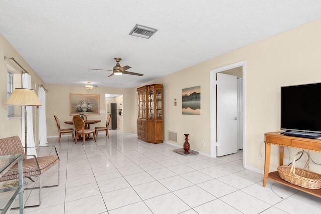 155 Mockingbird Ln, Delray Beach, FL 33445 - living area with light tile patterned floors, a ceiling fan, and visible vents