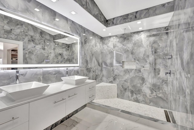 full bath featuring marble finish floor, a sink, and a marble finish shower