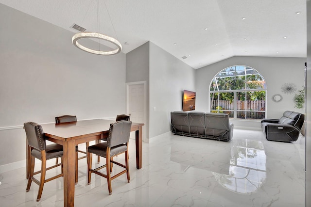 dining space featuring visible vents, marble finish floor, baseboards, and lofted ceiling