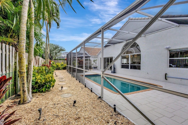 view of swimming pool with a fenced in pool, a patio, a fenced backyard, and a lanai