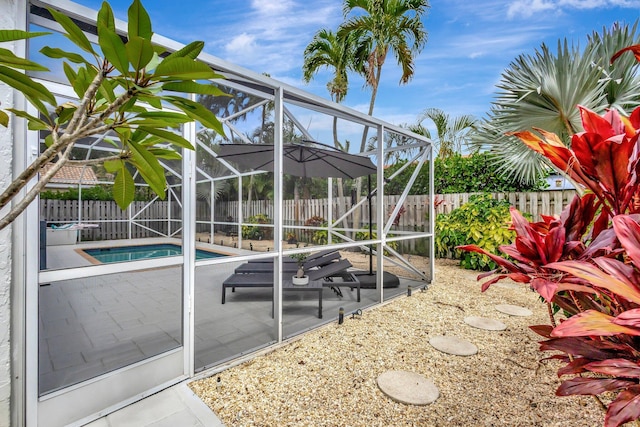 view of swimming pool with a lanai, a fenced backyard, a fenced in pool, and a patio area