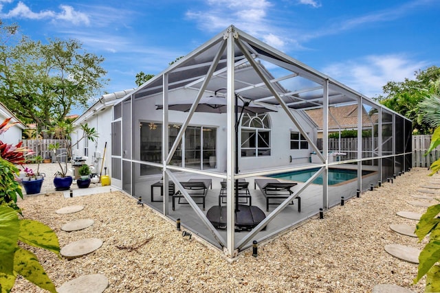 exterior space with a patio area, a fenced backyard, and glass enclosure
