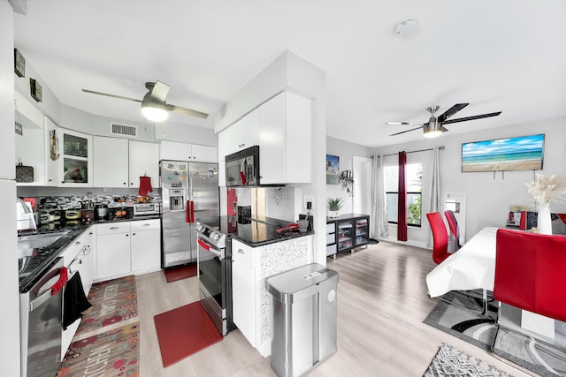 3750 NW 73rd Way, Coral Springs, FL 33065 - kitchen featuring a ceiling fan, stainless steel appliances, light wood-style flooring, and dark countertops