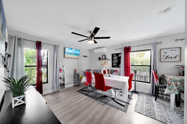 3750 NW 73rd Way, Coral Springs, FL 33065 - dining area with a wall mounted air conditioner, a textured ceiling, baseboards, and wood finished floors
