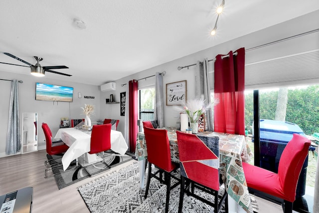 3750 NW 73rd Way, Coral Springs, FL 33065 - dining space with a wall mounted AC, ceiling fan, wood finished floors, and a textured ceiling