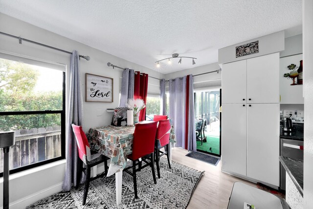 3750 NW 73rd Way, Coral Springs, FL 33065 - dining area with healthy amount of natural light, a textured ceiling, and light wood-style floors