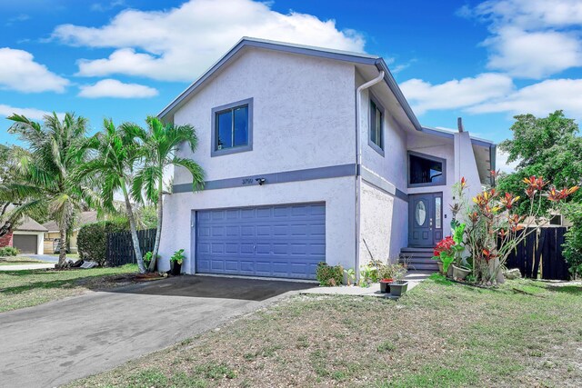 3750 NW 73rd Way, Coral Springs, FL 33065 - view of front of home with a garage, stucco siding, and driveway