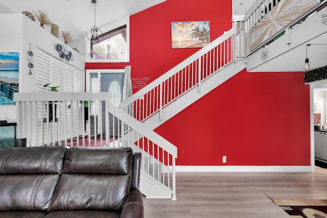 3750 NW 73rd Way, Coral Springs, FL 33065 - living area with wood finished floors, stairway, baseboards, and a towering ceiling