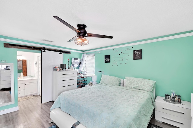 3750 NW 73rd Way, Coral Springs, FL 33065 - bedroom with wood finished floors, a barn door, ornamental molding, ensuite bathroom, and ceiling fan