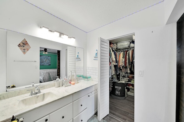 3750 NW 73rd Way, Coral Springs, FL 33065 - bathroom with connected bathroom, a ceiling fan, vanity, wood finished floors, and a textured ceiling