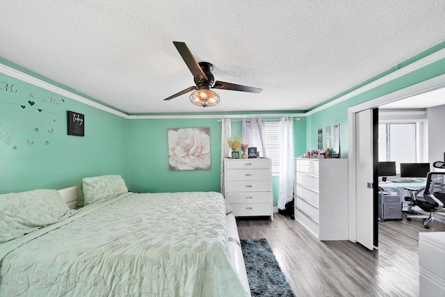 3750 NW 73rd Way, Coral Springs, FL 33065 - bedroom featuring multiple windows, a desk, ornamental molding, wood finished floors, and a textured ceiling