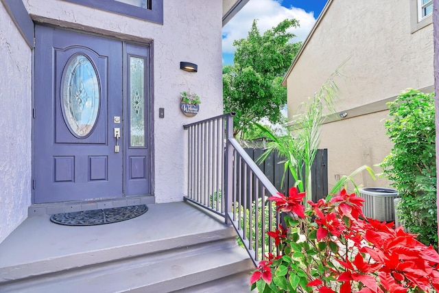 3750 NW 73rd Way, Coral Springs, FL 33065 - doorway to property with stucco siding and central air condition unit