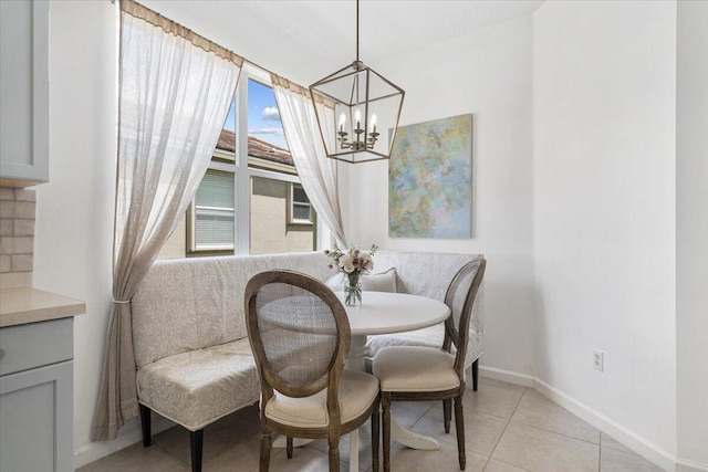 9961 SW Glenbrook Dr, Port Saint Lucie, FL 34987 - dining area with light tile patterned floors, a notable chandelier, and baseboards