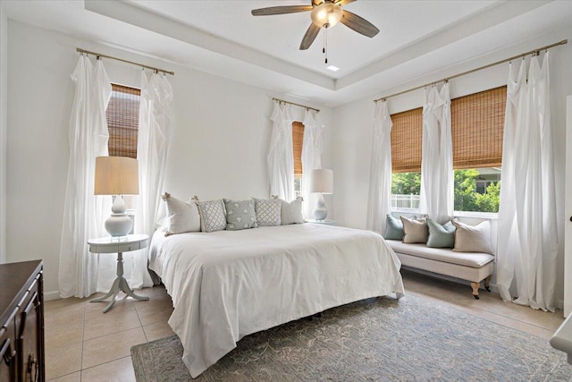 9961 SW Glenbrook Dr, Port Saint Lucie, FL 34987 - bedroom featuring a tray ceiling, ceiling fan, and light tile patterned floors
