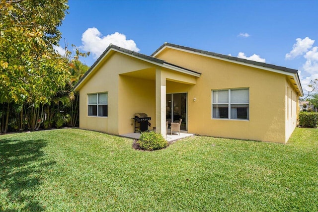 9961 SW Glenbrook Dr, Port Saint Lucie, FL 34987 - back of property featuring stucco siding, a yard, and a patio area