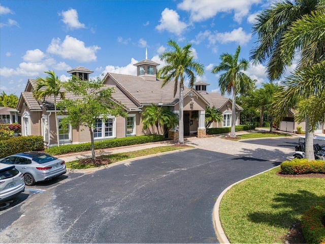 9961 SW Glenbrook Dr, Port Saint Lucie, FL 34987 - view of front of house with a tiled roof, stucco siding, and uncovered parking