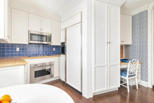 kitchen featuring white cabinetry, light countertops, dark wood finished floors, and stainless steel appliances