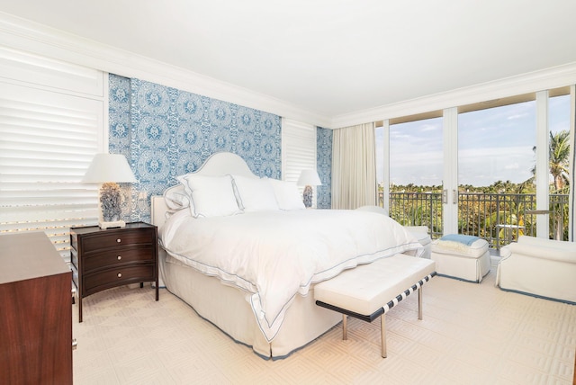 bedroom featuring crown molding, access to outside, and wallpapered walls