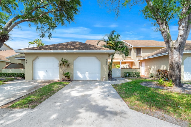 902 Maplewood Dr, Greenacres, FL 33415 - view of front of home featuring stucco siding and a garage