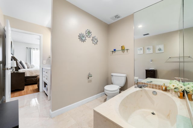 902 Maplewood Dr, Greenacres, FL 33415 - ensuite bathroom featuring a bath, ensuite bathroom, visible vents, and toilet
