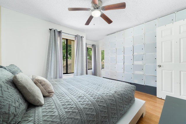 902 Maplewood Dr, Greenacres, FL 33415 - bedroom featuring a textured ceiling, wood finished floors, and a ceiling fan