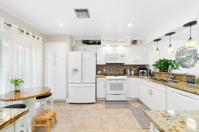 902 Maplewood Dr, Greenacres, FL 33415 - kitchen with white cabinetry, white appliances, backsplash, a sink, and visible vents
