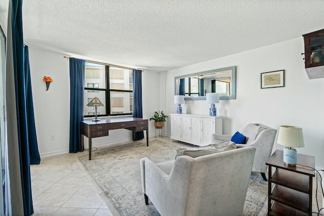 living area featuring baseboards, light tile patterned flooring, and a textured ceiling