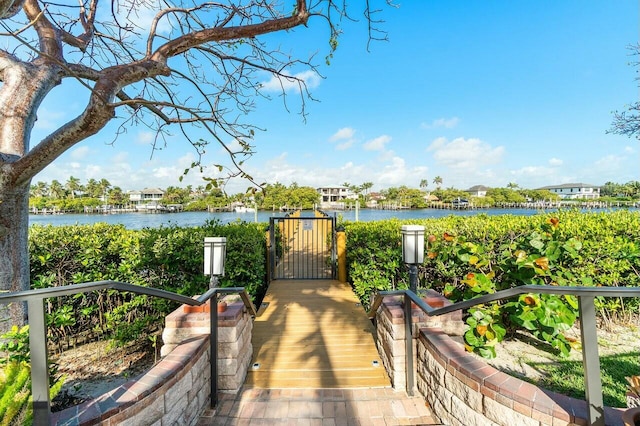 dock area with a gate and a water view