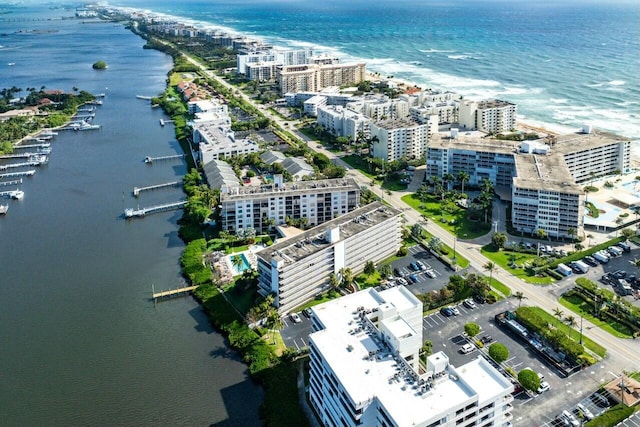 drone / aerial view featuring a water view and a view of city