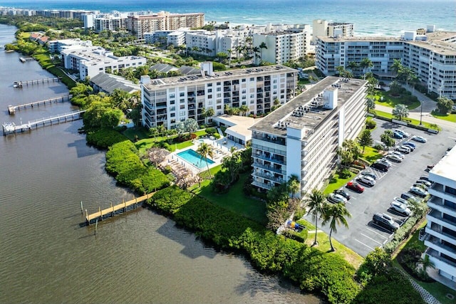 birds eye view of property featuring a water view and a view of city
