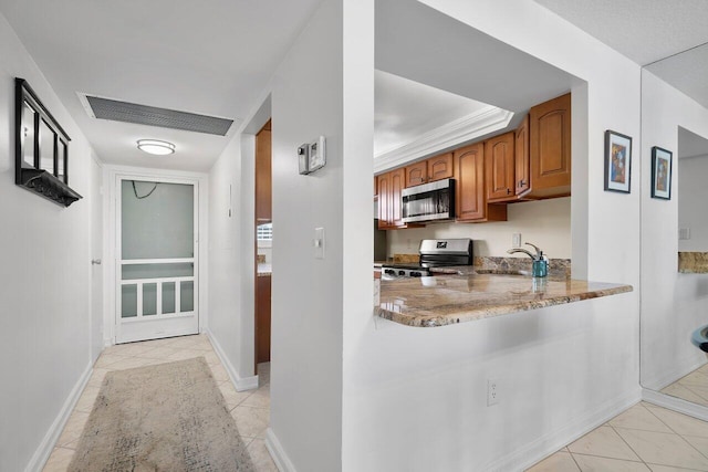kitchen with stainless steel appliances, a sink, visible vents, light stone countertops, and brown cabinetry