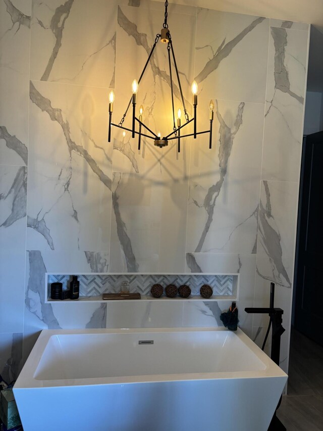 1071 S Header Canal Rd, Fort Pierce, FL 34945 - bathroom with a chandelier and a bathtub